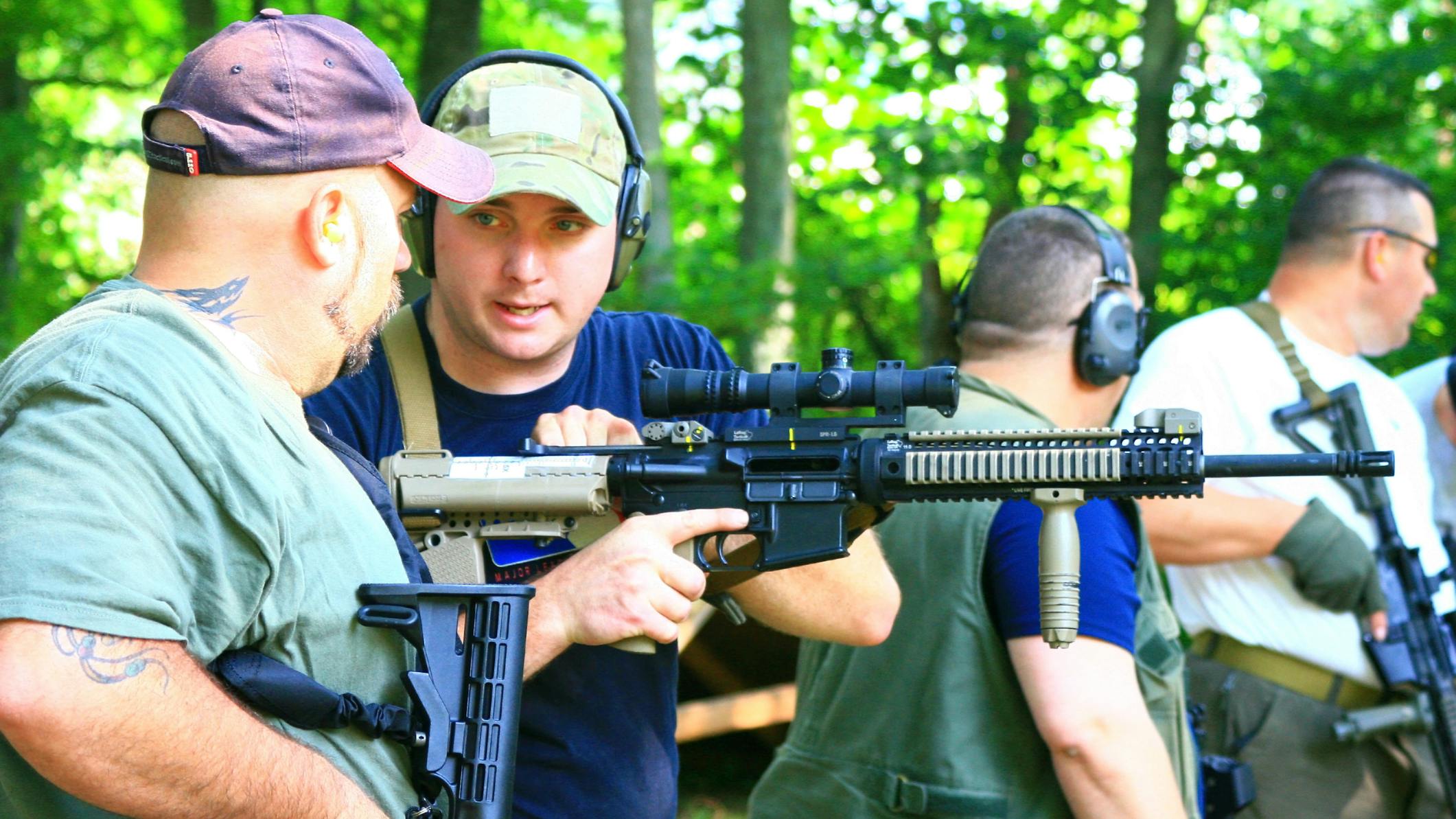 Firearms training instructor with a pupil at the range