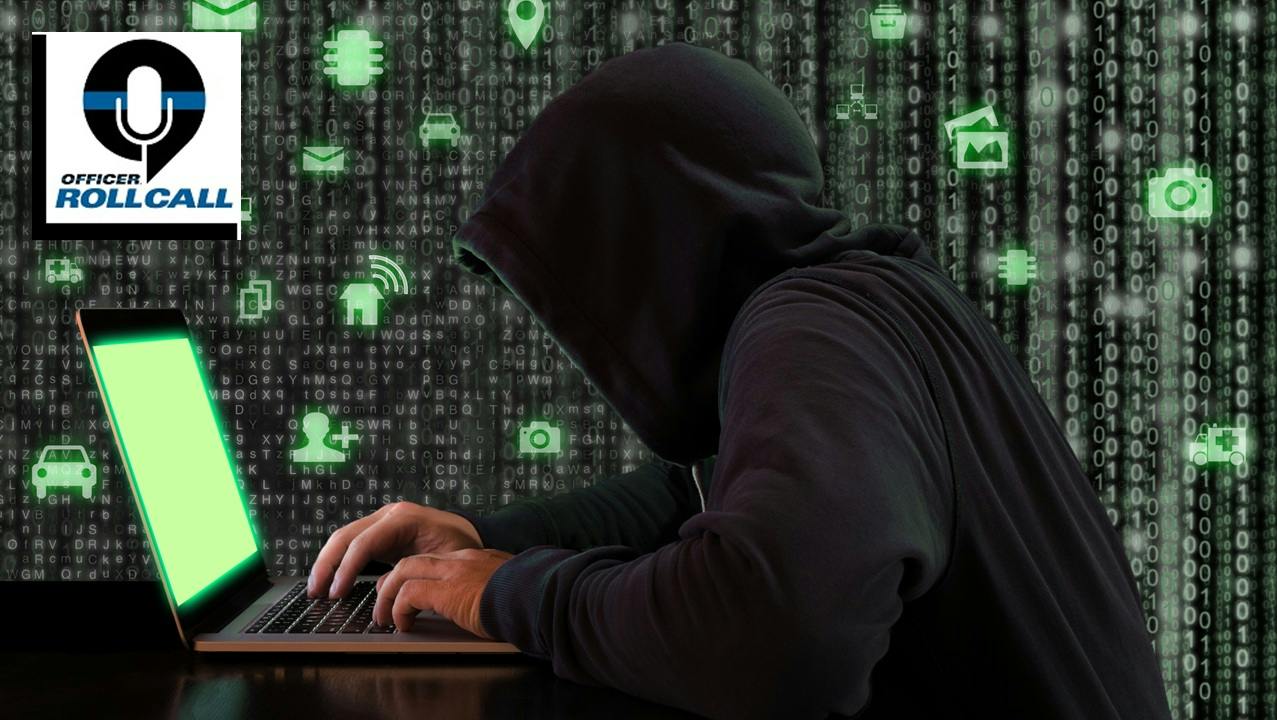 A hooded cybercriminal tries to hack into a website
