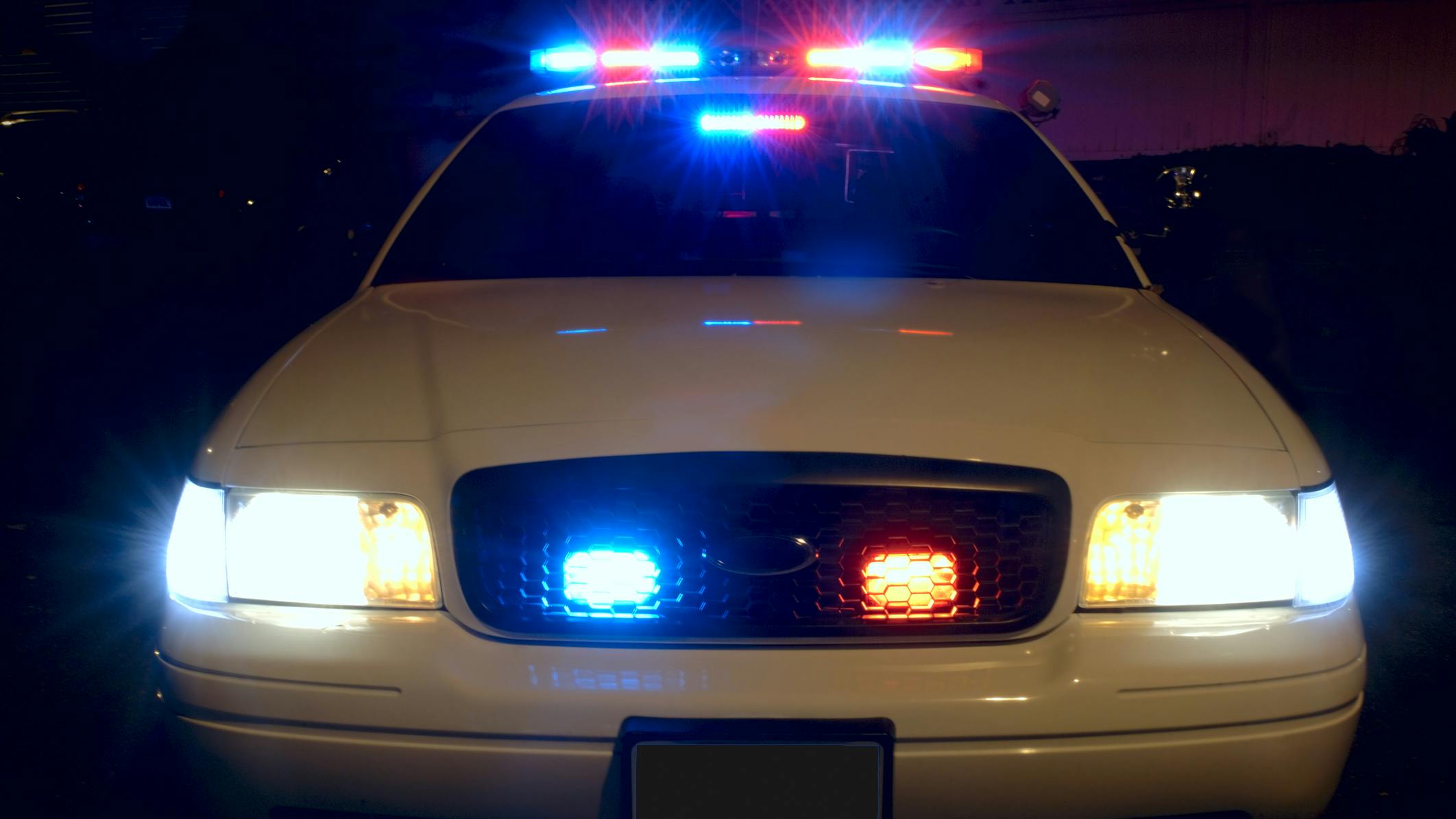 Front of police cruiser with emergency lights activated