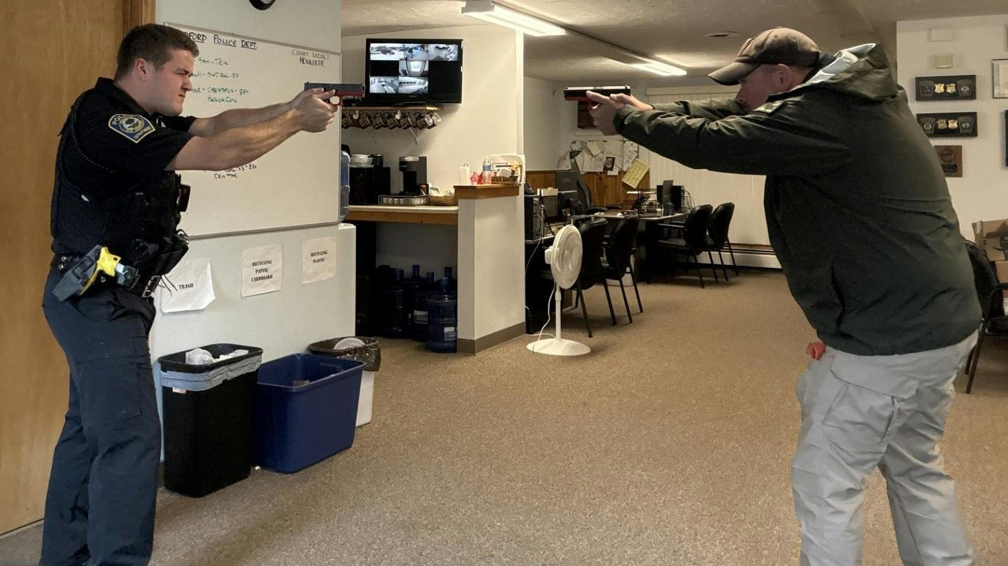 A training instructor and a trainee police officer participate in a head-to-head dry-fire exercise