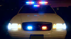 The front of a police cruiser with its emergency lights activated