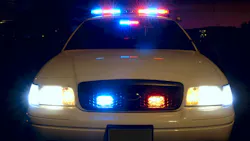 The front of a police cruiser with its emergency lights activated