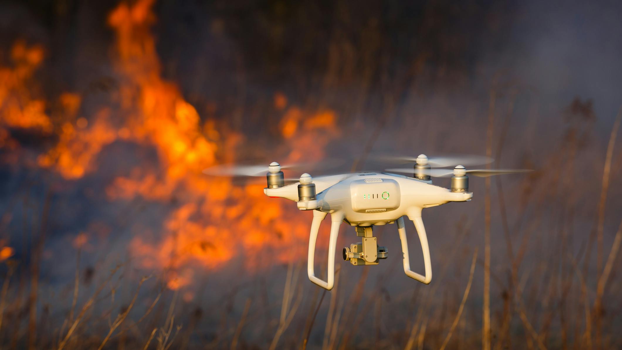 A drone flies near a wildfire