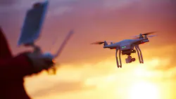 A pilot flies drone into the sunset