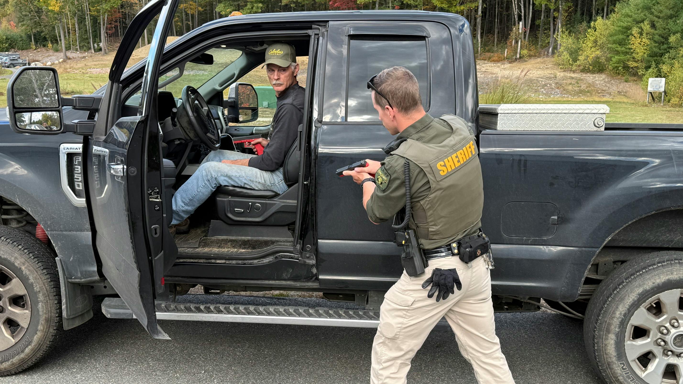 A deputy and a role player work through a vehicle-based training exercise