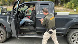 A deputy and a role player work through a vehicle-based training exercise