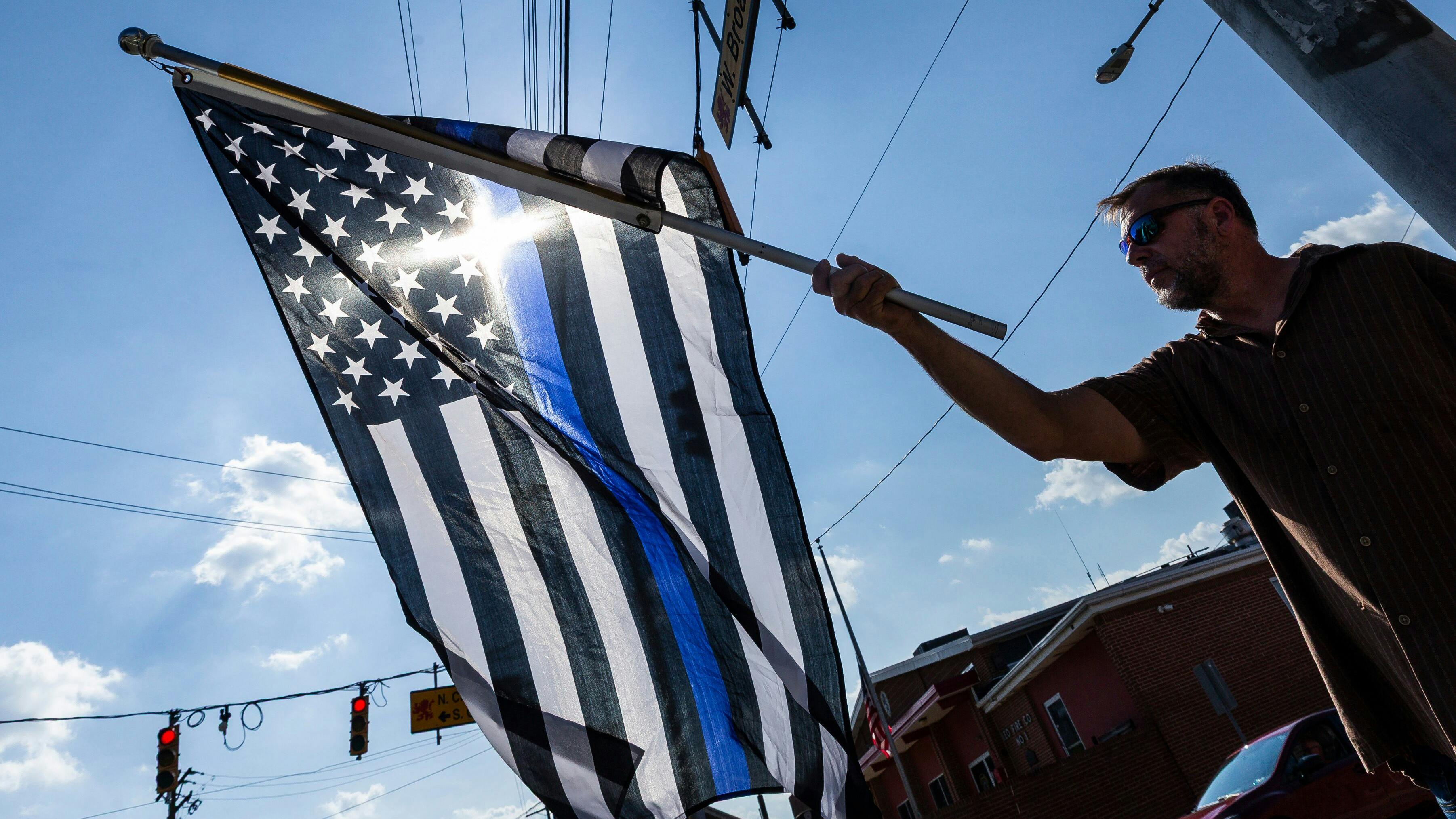 Mark Holloway flies his American Thin Blue Line flag following the ambush killing of three Northern York County Regional Police Department detectives