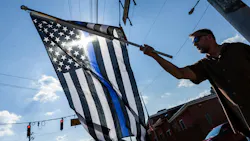 Mark Holloway flies his American Thin Blue Line flag following the ambush killing of three Northern York County Regional Police Department detectives