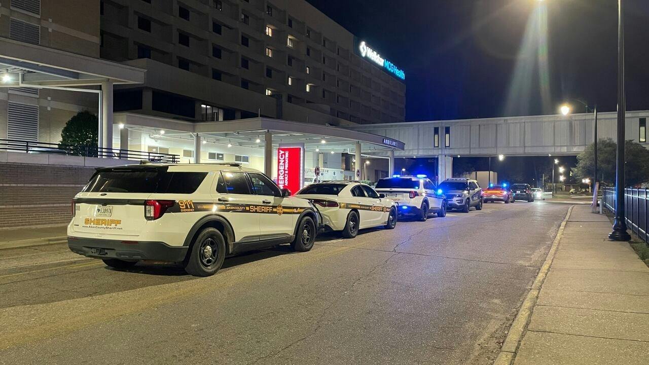 Aiken County Sheriff's Office cruisers wait outside a hospital after a deputy was shot