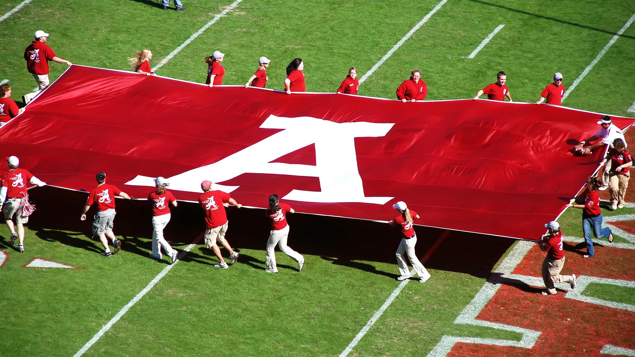A University of Alabama banner on the field during a game