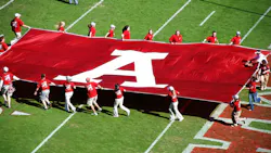 A University of Alabama banner on the field during a game