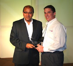 Xcellerex accepting trophy from Invensys Operations Management CEO and president Sudipta Bhattacharya.