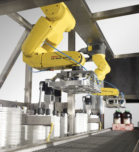 The robotic handle applicator (above) has an embedded industrial PC as its controller. Speeds to 60 cases a minute can be reache