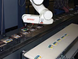 A mobile robotic work cell at Market Resource Packaging picks product sachets and places them on a preglued card with ?1D8-inch A mobile robotic work cell at Market Resource Packaging picks product sachets and places them on a preglued card with ?1D8-inch