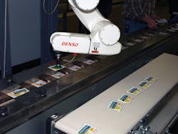 A mobile robotic work cell at Market Resource Packaging picks product sachets and places them on a preglued card with ?1D8-inch