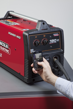 A mobile phone with a camera is being used to scan the 2D Microsoft Tag barcode on a Power MIG 180 to access information about t