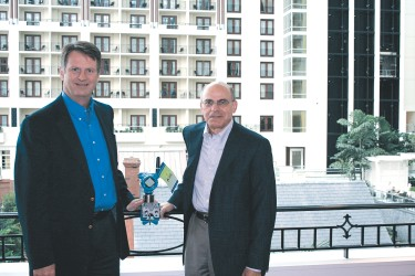 Emerson Process Management executives Steve Sonnenberg (left) and John Berra show one of the 70 instruments installed at the Exc
