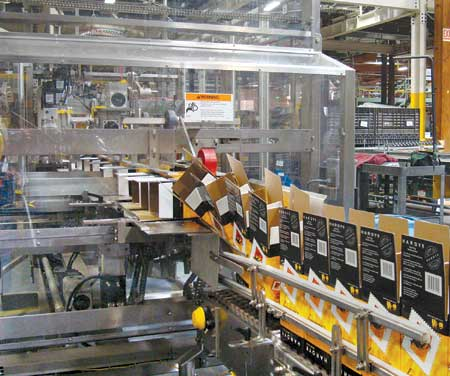 The case erector forms the wine boxes and gently transforms them from their sides to an upright position