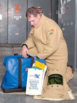 This electrical worker is preparing to don Oberon Company ARC65 FRrated personal protective equipment(PPE). This clothing system This electrical worker is preparing to don Oberon Company ARC65 FRrated personal protective equipment(PPE). This clothing system