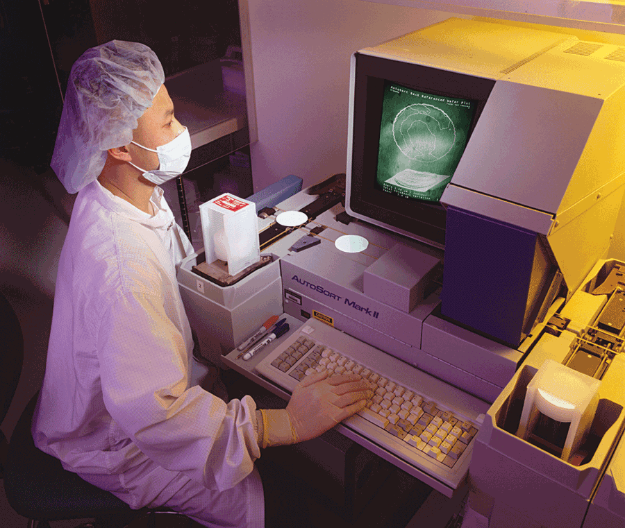 An inspector at Crystal Technology checks wafers that the company produces for acousto-optic components. Test specifications and