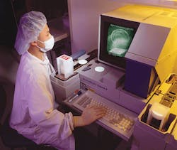 An inspector at Crystal Technology checks wafers that the company produces for acousto-optic components. Test specifications and