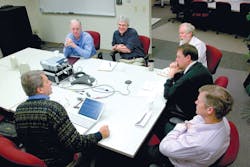 Automation World Editor in Chief Gary Mintchell, bottom left, talks with (left to right)