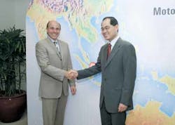 : Ed Zander, Chairman and Chief Executive Officer of Motorola (left), is shown with Singapore Trade and Industry Minister Lim Hn