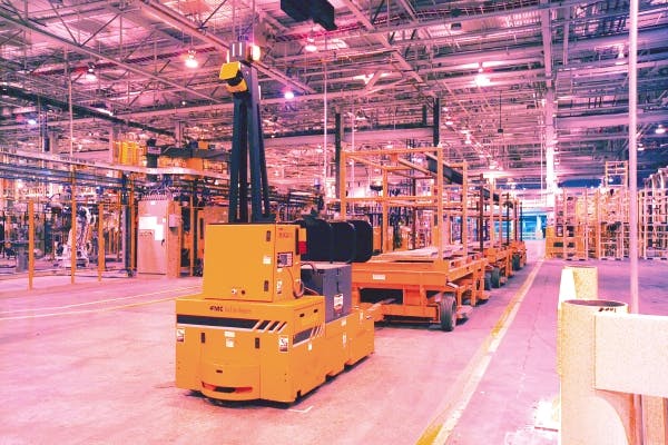 A tow-style AGV works in a Ford plant.