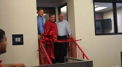 Cutting the ribbon (L-R) Kevin Hutchinson, Mayor, Columbia, Ill., Paul Galeski, CEO, and Kirk Norris, SVP Strategic Manufacturing Solutions. Cutting the ribbon (L-R) Kevin Hutchinson, Mayor, Columbia, Ill., Paul Galeski, CEO, and Kirk Norris, SVP Strategic Manufacturing Solutions.