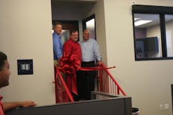 Cutting the ribbon (L-R) Kevin Hutchinson, Mayor, Columbia, Ill., Paul Galeski, CEO, and Kirk Norris, SVP Strategic Manufacturing Solutions. Cutting the ribbon (L-R) Kevin Hutchinson, Mayor, Columbia, Ill., Paul Galeski, CEO, and Kirk Norris, SVP Strategic Manufacturing Solutions.