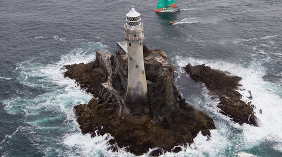 Groupama Sailing Team, skippered by Franck Cammas from France and CAMPER with Emirates Team New Zealand, skippered by Chris Nicholson from Australia, rounding Fastnet Rock. Photo credit: IAN ROMAN/Volvo Ocean Race