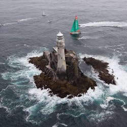Groupama Sailing Team, skippered by Franck Cammas from France and CAMPER with Emirates Team New Zealand, skippered by Chris Nicholson from Australia, rounding Fastnet Rock. Photo credit: IAN ROMAN/Volvo Ocean Race