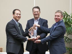 Bristol-Myers Squibb representatives Chris Stevens (left) and Dave Gleeson (far right) receive the award from Steven Sonnenberg