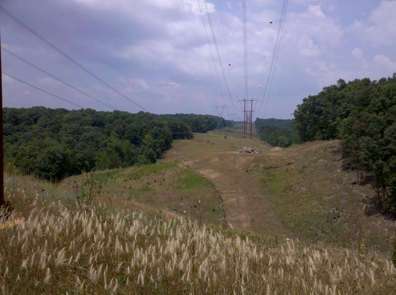 These power lines have FAA-required steady-beacon obstruction lights to warn aircraft, and the lights must be monitored in inaccessible mountainous terrain.