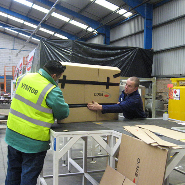 For a Kaizen event called 3P (Production Preparation Process), ESCO teams mock up different ideas to solve problems. This team is working on a grinding station designed to capture particles to reduce eye injuries.