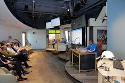 Microsoft employees act out a scenario in the Microsoft Technology Center Houston&rsquo;s Envisioning Center to demonstrate how cloud technologies could be used in the oil and gas industry.