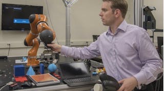 NIST engineer Jeremy Marvel adjusts a robotic arm used to study human-robot interactions. According to a NIST economic study on advanced robotics and automation&mdash;one of four reports on advanced manufacturing&mdash;Marvel&rsquo;s work is the type of research needed to fortify and facilitate this emerging field. Credit: F. Webber/NIST