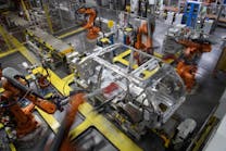 Robots in assembly operations at Land Rover factory.