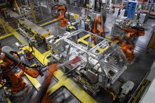 Robots in assembly operations at Land Rover factory.