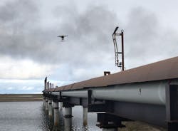 A drone flies over in-service flare stacks, identifying corrosion and marking the locations for maintenance. A drone flies over in-service flare stacks, identifying corrosion and marking the locations for maintenance.