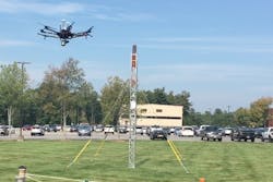 At an outdoor test site at GE Global Research, a drone flies around a small tower to create a 3D model of the asset.