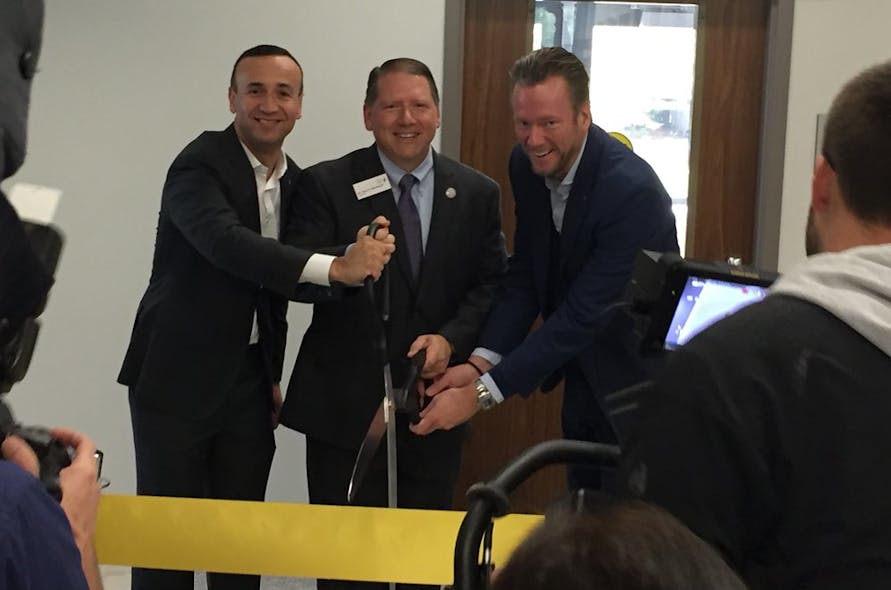Jon DeSouza, Troy Hammond and Philip Harting (left to right) cut the ribbon at the dedication of the Harting Electronics Lab at North Central College in Naperville, Ill.
