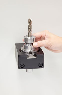 A CNC operator on the shop floor puts the tool’s holder in an RFID read station and then the tag is read by the ToolConnect system. A CNC operator on the shop floor puts the tool’s holder in an RFID read station and then the tag is read by the ToolConnect system.