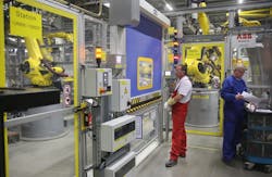 This image from a Porsche factory captures the ability of fewer workers to manage the tasks once handled by several employees.
