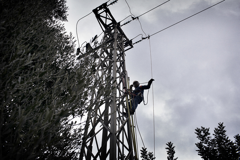 A technician works on an Enel power pole in Italy. Source: Enel