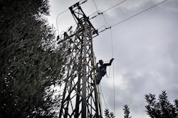 A technician works on an Enel power pole in Italy. Source: Enel A technician works on an Enel power pole in Italy. Source: Enel