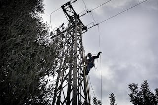 A technician works on an Enel power pole in Italy. Source: Enel