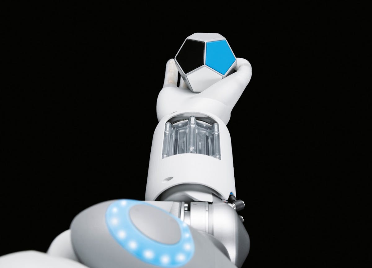 The Festo BionicSoftHand and the 12-sided cube used in training its motion capabilities.