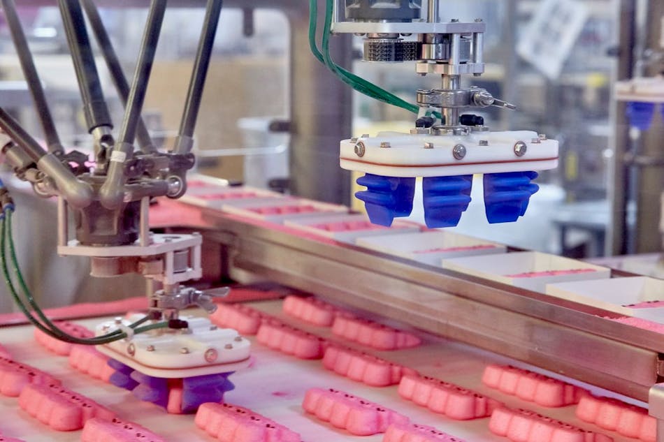 The Soft Robotics gripper, designed to mimic the human hand, gently and accurately picks up Peeps to load into trays.