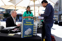 Russell signing copies of his book &apos;Human Compatible: Artificial Intelligence and the Problem of Control&apos; at the TechCrunch event. Source: TechCrunch